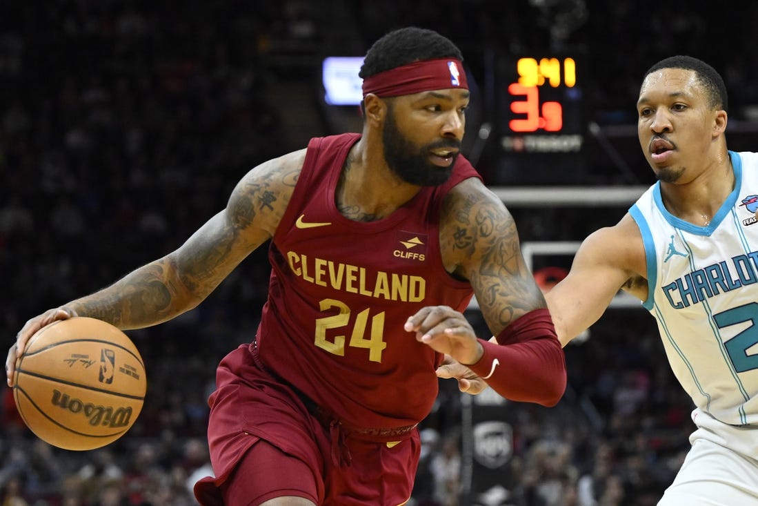 Mar 25, 2024; Cleveland, Ohio, USA; Cleveland Cavaliers forward Marcus Morris Sr. (24) dribbles beside Charlotte Hornets forward Grant Williams (2) in the second quarter at Rocket Mortgage FieldHouse. Mandatory Credit: David Richard-USA TODAY Sports