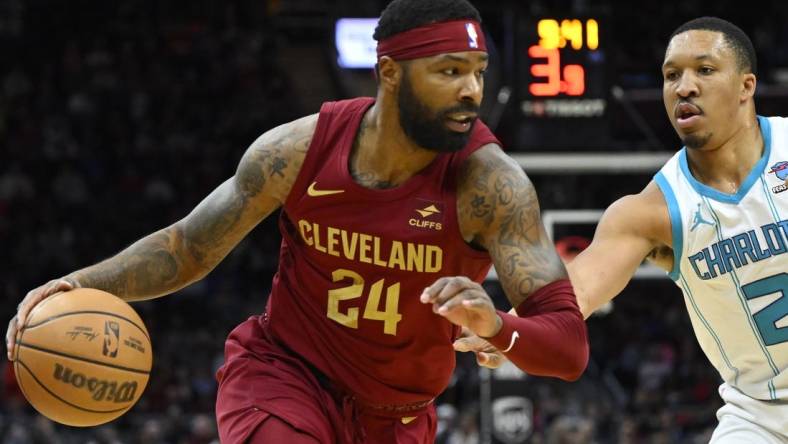 Mar 25, 2024; Cleveland, Ohio, USA; Cleveland Cavaliers forward Marcus Morris Sr. (24) dribbles beside Charlotte Hornets forward Grant Williams (2) in the second quarter at Rocket Mortgage FieldHouse. Mandatory Credit: David Richard-USA TODAY Sports