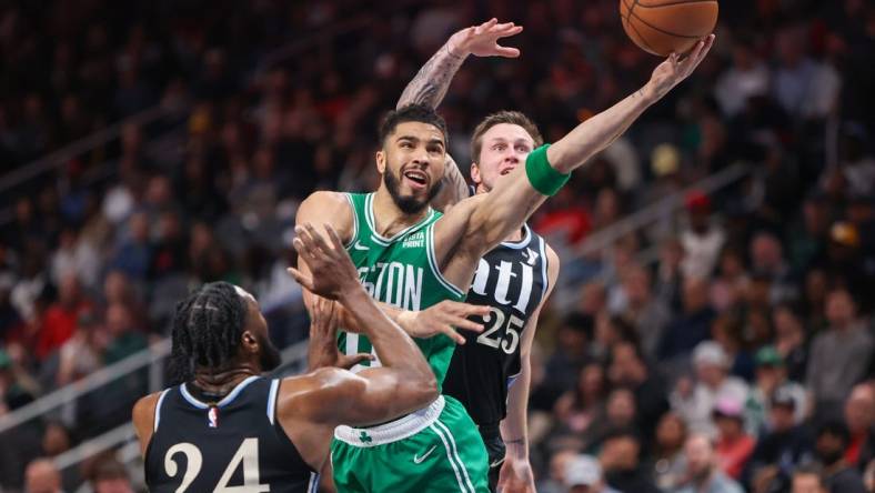 Mar 25, 2024; Atlanta, Georgia, USA; Boston Celtics forward Jayson Tatum (0) shoots past Atlanta Hawks forward Bruno Fernando (24) and guard Garrison Mathews (25) in the second quarter at State Farm Arena. Mandatory Credit: Brett Davis-USA TODAY Sports