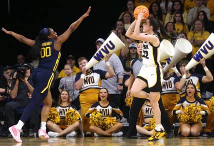 Iowa’s Caitlin Clark (22) shoots as West Virginia’s Jayla Hemingway (00) defends in a NCAA Tournament round of 32 game Monday, March 25, 2024 at Carver-Hawkeye Arena in Iowa City, Iowa.