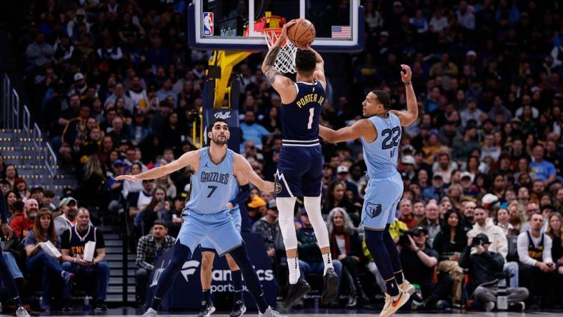 Mar 25, 2024; Denver, Colorado, USA; Denver Nuggets forward Michael Porter Jr. (1) attempts a three point shot against Memphis Grizzlies guard Desmond Bane (22) and forward Santi Aldama (7) in the first quarter at Ball Arena. Mandatory Credit: Isaiah J. Downing-USA TODAY Sports