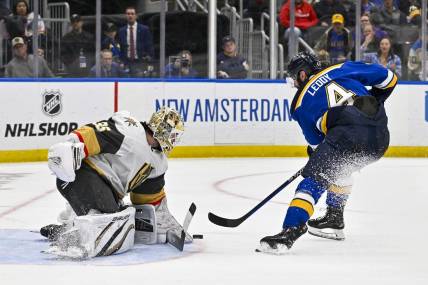 Mar 25, 2024; St. Louis, Missouri, USA;  Vegas Golden Knights goaltender Logan Thompson (36) defends the net against St. Louis Blues defenseman Nick Leddy (4) during the second period at Enterprise Center. Mandatory Credit: Jeff Curry-USA TODAY Sports