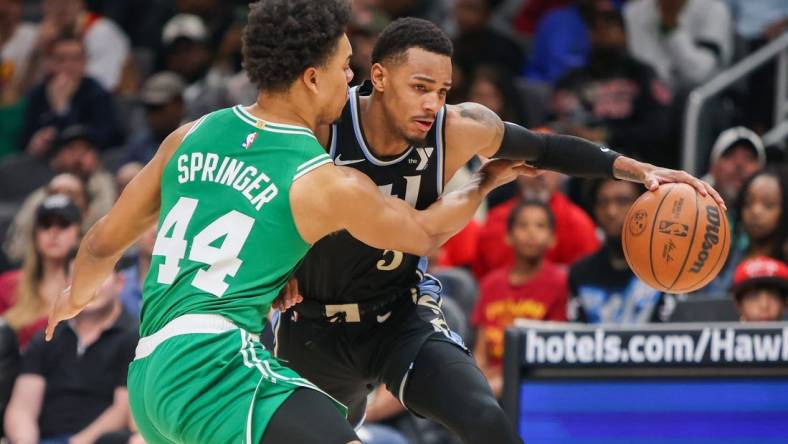 Mar 25, 2024; Atlanta, Georgia, USA; Boston Celtics guard Jaden Springer (44) defends Atlanta Hawks guard Dejounte Murray (5) in the second half at State Farm Arena. Mandatory Credit: Brett Davis-USA TODAY Sports