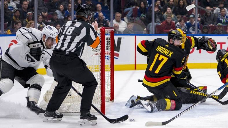 Mar 25, 2024; Vancouver, British Columbia, CAN; Vancouver Canucks defenseman Filip Hronek (17) watches as Los Angeles Kings forward Anze Kopitar (11) scores on goalie Casey DeSmith (29) in the second period at Rogers Arena. Mandatory Credit: Bob Frid-USA TODAY Sports