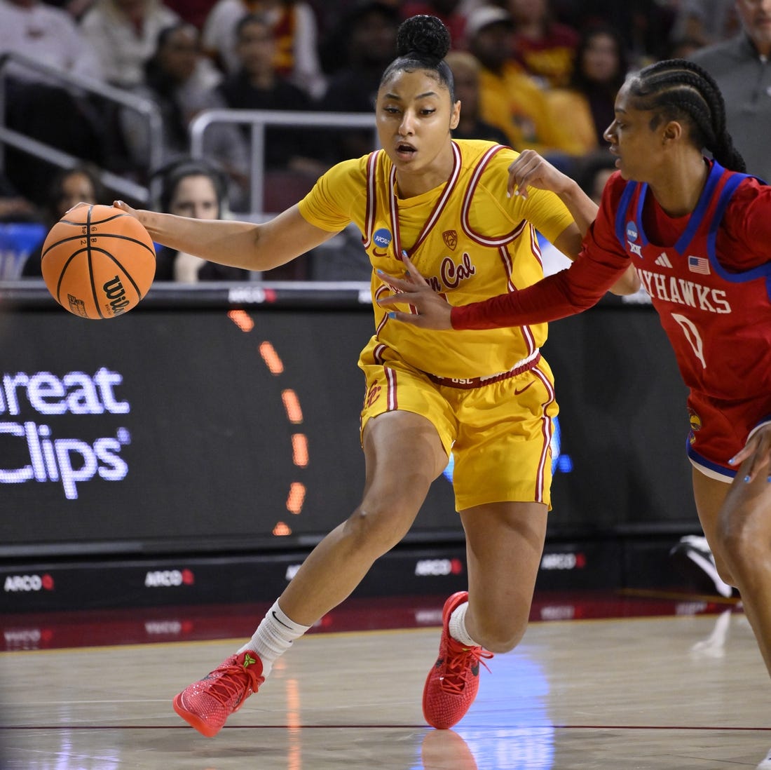 Mar 25, 2024; Los Angeles, CA, USA; USC Trojans guard JuJu Watkins (12) drives to the basket as Kansas Jayhawks guard Wyvette Mayberry (0) defends during an NCAA Women’s Tournament 2nd round game at Galen Center. Mandatory Credit: Robert Hanashiro-USA TODAY Sports