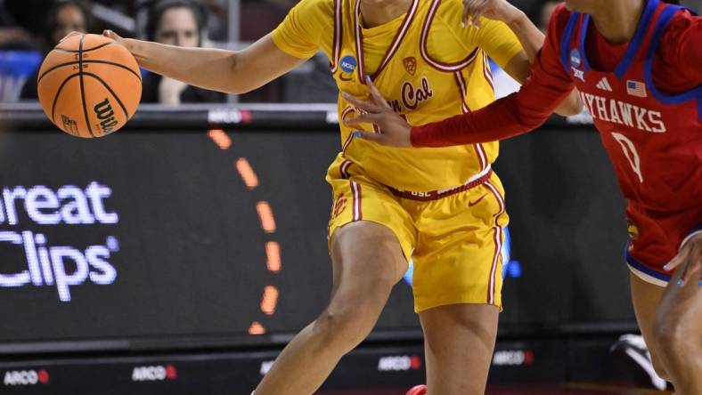 Mar 25, 2024; Los Angeles, CA, USA; USC Trojans guard JuJu Watkins (12) drives to the basket as Kansas Jayhawks guard Wyvette Mayberry (0) defends during an NCAA Women’s Tournament 2nd round game at Galen Center. Mandatory Credit: Robert Hanashiro-USA TODAY Sports