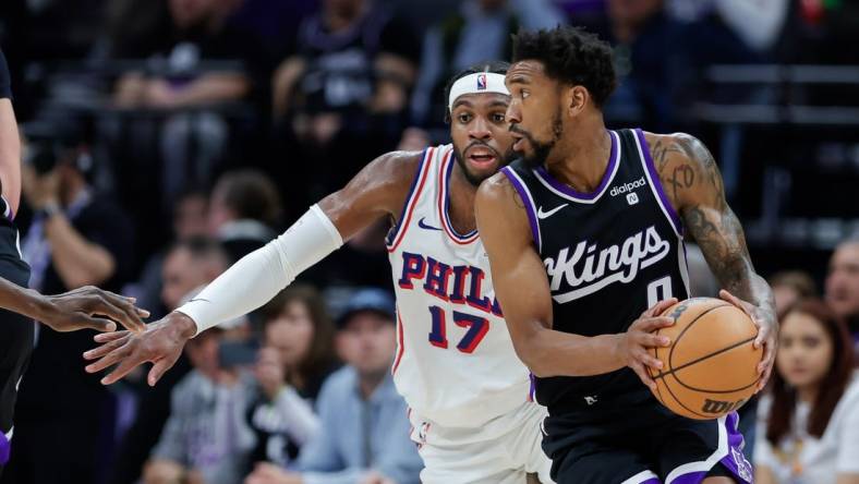 Mar 25, 2024; Sacramento, California, USA; Sacramento Kings guard Malik Monk (0) controls the ball against Philadelphia 76ers guard Buddy Hield (17) during the second quarter at Golden 1 Center. Mandatory Credit: Sergio Estrada-USA TODAY Sports