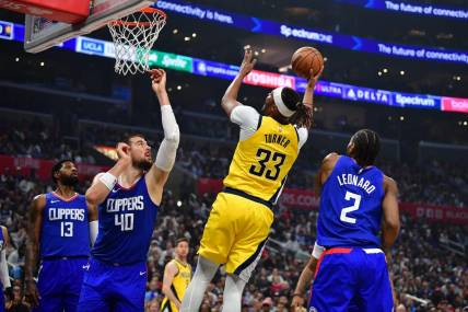 Mar 25, 2024; Los Angeles, California, USA; Indiana Pacers center Myles Turner (33) shoots against Los Angeles Clippers center Ivica Zubac (40) and forward Kawhi Leonard (2) during the first half at Crypto.com Arena. Mandatory Credit: Gary A. Vasquez-USA TODAY Sports