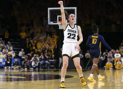 Iowa’s Caitlin Clark (22) holds a pose as she celebrates a made 3-point basket against West Virginia in a NCAA Tournament round of 32 game Monday, March 25, 2024 at Carver-Hawkeye Arena.