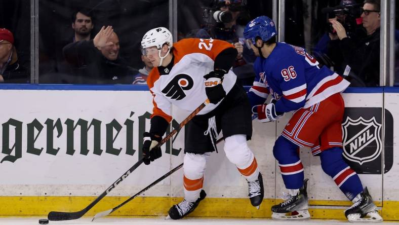 Mar 26, 2024; New York, New York, USA; Philadelphia Flyers defenseman Ronnie Attard (23) looks to pass the puck against New York Rangers center Jack Roslovic (96) during the first period at Madison Square Garden. Mandatory Credit: Brad Penner-USA TODAY Sports