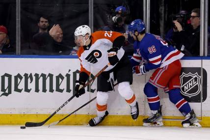 Mar 26, 2024; New York, New York, USA; Philadelphia Flyers defenseman Ronnie Attard (23) looks to pass the puck against New York Rangers center Jack Roslovic (96) during the first period at Madison Square Garden. Mandatory Credit: Brad Penner-USA TODAY Sports