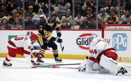 Mar 26, 2024; Pittsburgh, Pennsylvania, USA; Carolina Hurricanes left wing Jake Guentzel (59) and goaltender Pyotr Kochetkov (52) defend Pittsburgh Penguins right wing Bryan Rust (17) during the first period at PPG Paints Arena. Mandatory Credit: Charles LeClaire-USA TODAY Sports