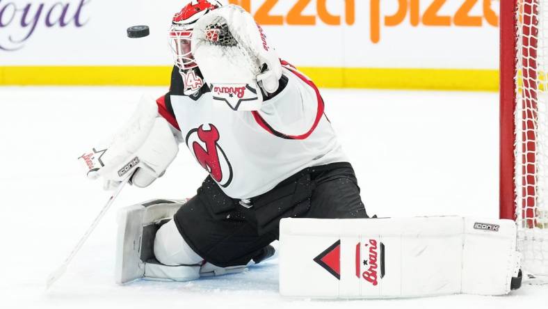 Mar 26, 2024; Toronto, Ontario, CAN; New Jersey Devils goaltender Jake Allen (34) attempts to stop the puck against the Toronto Maple Leafs during the first period at Scotiabank Arena. Mandatory Credit: Nick Turchiaro-USA TODAY Sports