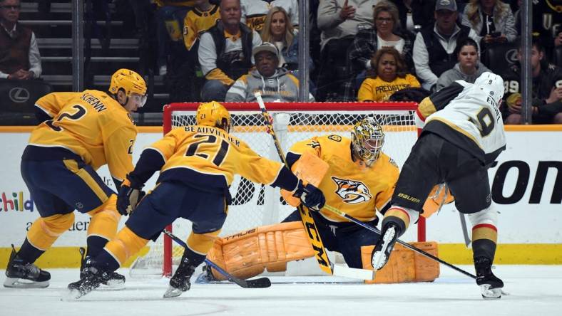 Mar 26, 2024; Nashville, Tennessee, USA; Nashville Predators goaltender Juuse Saros (74) makes a save on a shot by Vegas Golden Knights center Jack Eichel (9) during the first period at Bridgestone Arena. Mandatory Credit: Christopher Hanewinckel-USA TODAY Sports