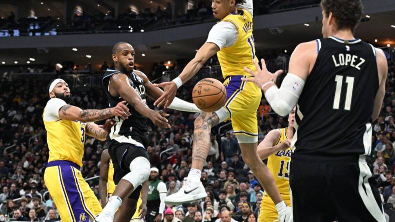 Mar 26, 2024; Milwaukee, Wisconsin, USA; Milwaukee Bucks forward Khris Middleton (22) drives tot the basket against Los Angeles Lakers center Jaxson Hayes (11) in the first half at Fiserv Forum. Mandatory Credit: Michael McLoone-USA TODAY Sports