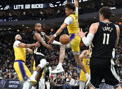 Mar 26, 2024; Milwaukee, Wisconsin, USA; Milwaukee Bucks forward Khris Middleton (22) drives tot the basket against Los Angeles Lakers center Jaxson Hayes (11) in the first half at Fiserv Forum. Mandatory Credit: Michael McLoone-USA TODAY Sports