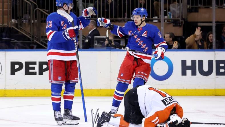 Mar 26, 2024; New York, New York, USA; New York Rangers left wing Alexis Lafreniere (13) celebrates his goal with left wing Artemi Panarin (10) in front of Philadelphia Flyers right wing Travis Konecny (11) during the third period at Madison Square Garden. Mandatory Credit: Brad Penner-USA TODAY Sports