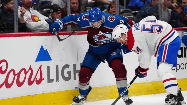 Mar 26, 2024; Denver, Colorado, USA; Montreal Canadiens defenseman Jordan Harris (54) and Colorado Avalanche left wing Zach Parise (9) battle for the puck in the first period at Ball Arena. Mandatory Credit: Ron Chenoy-USA TODAY Sports