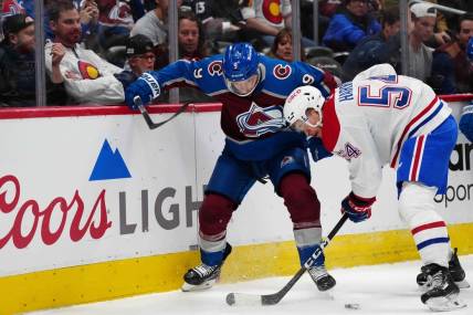 Mar 26, 2024; Denver, Colorado, USA; Montreal Canadiens defenseman Jordan Harris (54) and Colorado Avalanche left wing Zach Parise (9) battle for the puck in the first period at Ball Arena. Mandatory Credit: Ron Chenoy-USA TODAY Sports