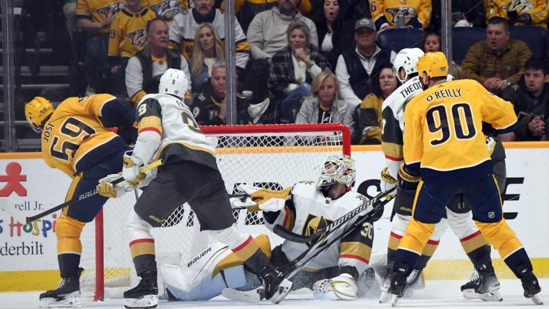 Mar 26, 2024; Nashville, Tennessee, USA; Nashville Predators defenseman Roman Josi (59) scores the game-winning goal against Vegas Golden Knights goaltender Jiri Patera (30) in overtime at Bridgestone Arena. Mandatory Credit: Christopher Hanewinckel-USA TODAY Sports