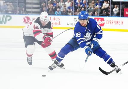 Mar 26, 2024; Toronto, Ontario, CAN; Toronto Maple Leafs right wing William Nylander (88) battles for the puck with New Jersey Devils defenseman Brendan Smith (2) during the third period at Scotiabank Arena. Mandatory Credit: Nick Turchiaro-USA TODAY Sports