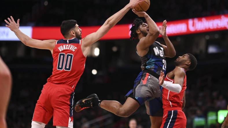 Mar 27, 2024; Washington, District of Columbia, USA;  Washington Wizards forward Tristan Vukcevic (00) blocks Brooklyn Nets guard Cam Thomas (24) shot during the first half at Capital One Arena. Mandatory Credit: Tommy Gilligan-USA TODAY Sports