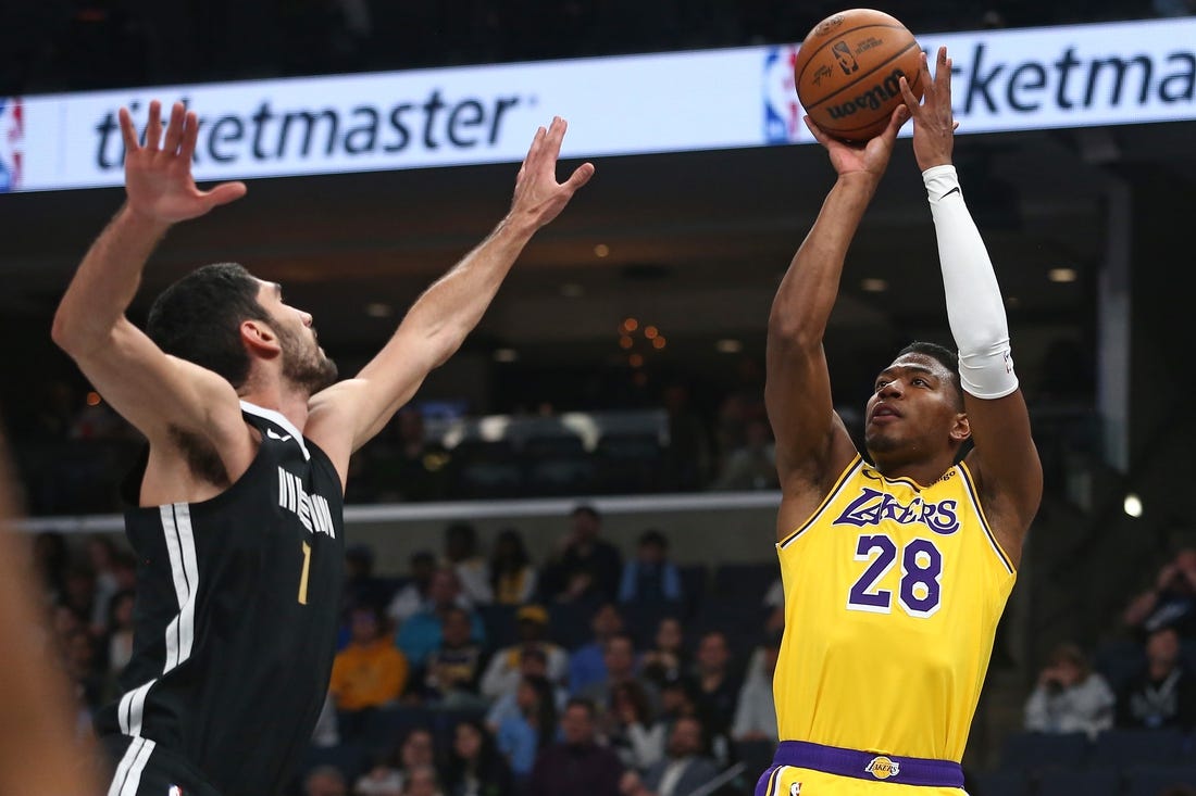 Mar 27, 2024; Memphis, Tennessee, USA; Los Angeles Lakers forward Rui Hachimura (28) shoots as Memphis Grizzlies forward-center Santi Aldama (7) defends during the first half at FedExForum. Mandatory Credit: Petre Thomas-USA TODAY Sports