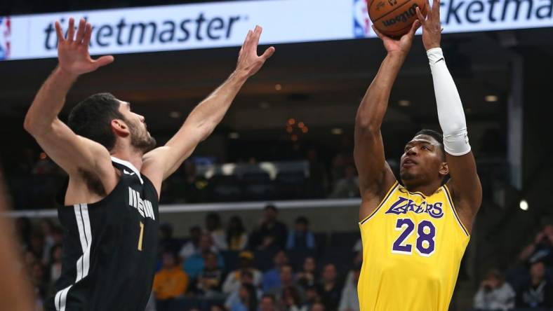 Mar 27, 2024; Memphis, Tennessee, USA; Los Angeles Lakers forward Rui Hachimura (28) shoots as Memphis Grizzlies forward-center Santi Aldama (7) defends during the first half at FedExForum. Mandatory Credit: Petre Thomas-USA TODAY Sports