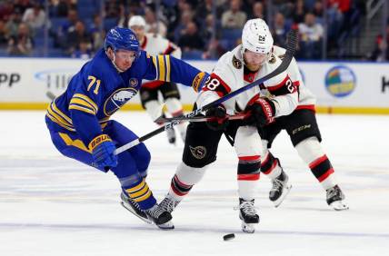 Mar 27, 2024; Buffalo, New York, USA;  Buffalo Sabres left wing Victor Olofsson (71) and Ottawa Senators right wing Claude Giroux (28) battle for a loose puck during the second period at KeyBank Center. Mandatory Credit: Timothy T. Ludwig-USA TODAY Sports