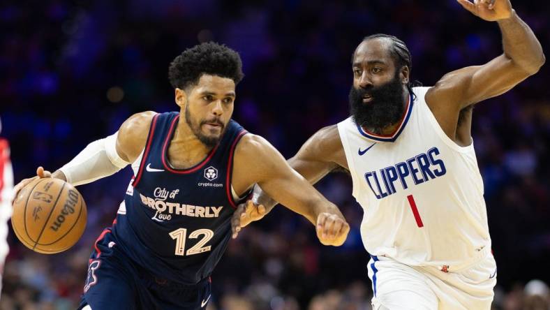 Mar 27, 2024; Philadelphia, Pennsylvania, USA; Philadelphia 76ers forward Tobias Harris (12) dribbles the ball against LA Clippers guard James Harden (1) during the second quarter at Wells Fargo Center. Mandatory Credit: Bill Streicher-USA TODAY Sports