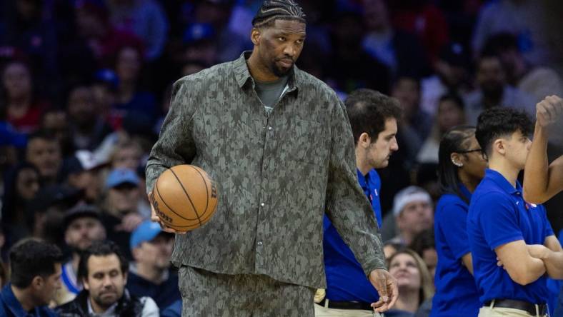 Mar 27, 2024; Philadelphia, Pennsylvania, USA; Injured Philadelphia 76ers center Joel Embiid dribbles the ball during a timeout in the second quarter against the LA Clippers at Wells Fargo Center. Mandatory Credit: Bill Streicher-USA TODAY Sports