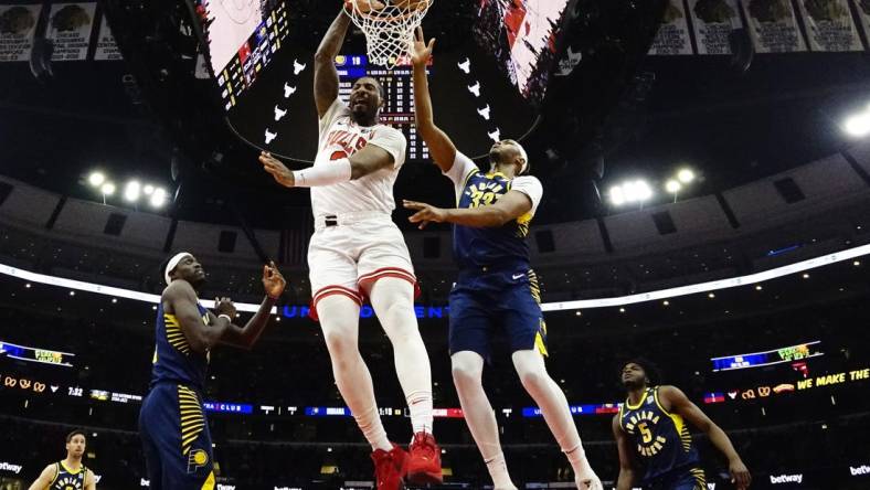 Mar 27, 2024; Chicago, Illinois, USA; Chicago Bulls center Andre Drummond (3) dunks on Indiana Pacers center Myles Turner (33) during the first quarter at United Center. Mandatory Credit: David Banks-USA TODAY Sports