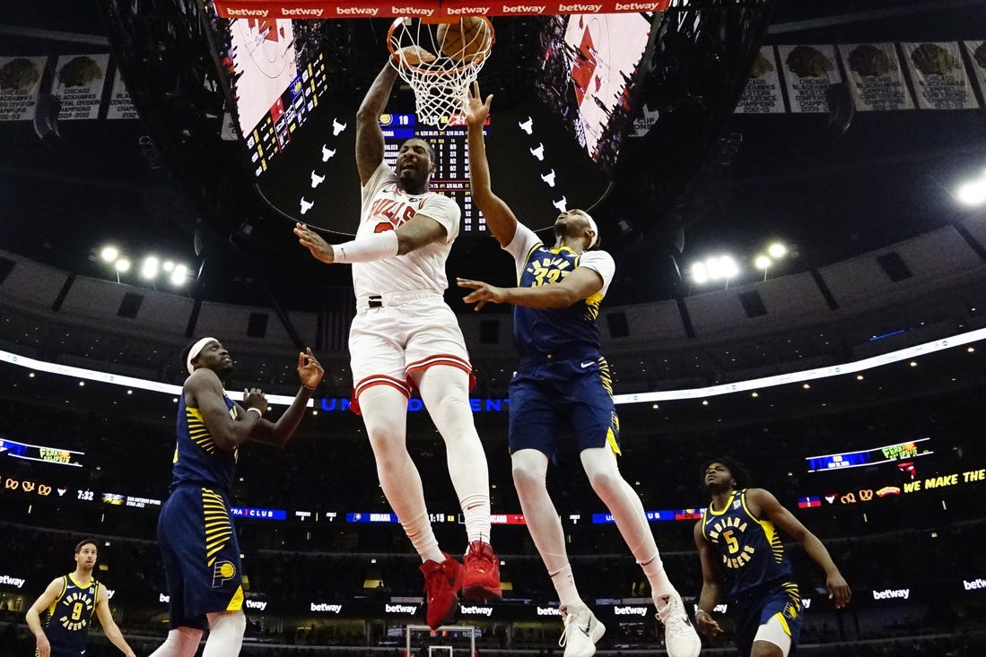 Mar 27, 2024; Chicago, Illinois, USA; Chicago Bulls center Andre Drummond (3) dunks on Indiana Pacers center Myles Turner (33) during the first quarter at United Center. Mandatory Credit: David Banks-USA TODAY Sports