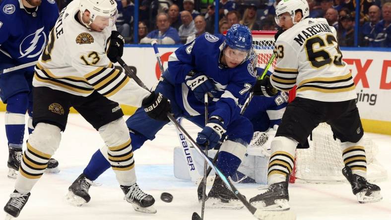 Mar 27, 2024; Tampa, Florida, USA; Tampa Bay Lightning defenseman Emil Martinsen Lilleberg (78) defends Boston Bruins center Charlie Coyle (13) and left wing Brad Marchand (63) during the second period at Amalie Arena. Mandatory Credit: Kim Klement Neitzel-USA TODAY Sports