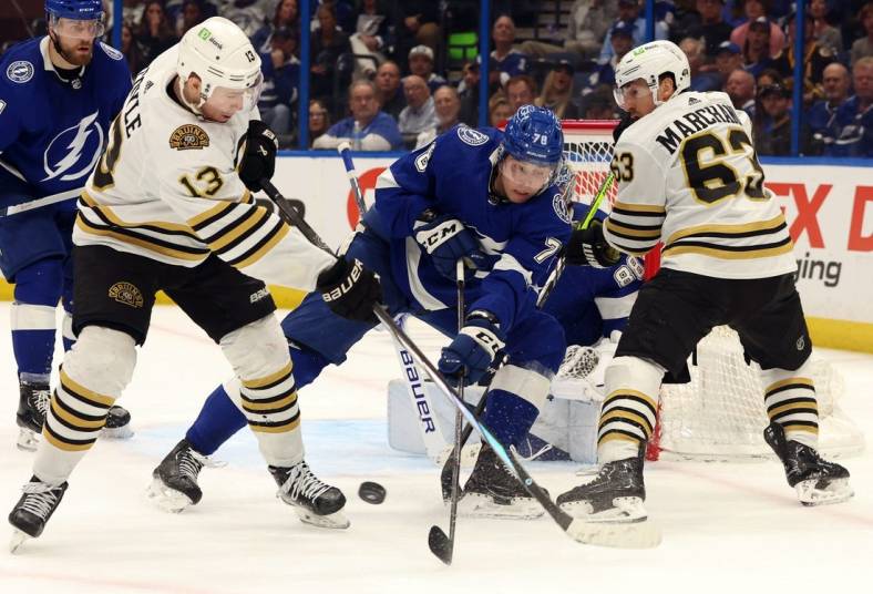 Mar 27, 2024; Tampa, Florida, USA; Tampa Bay Lightning defenseman Emil Martinsen Lilleberg (78) defends Boston Bruins center Charlie Coyle (13) and left wing Brad Marchand (63) during the second period at Amalie Arena. Mandatory Credit: Kim Klement Neitzel-USA TODAY Sports