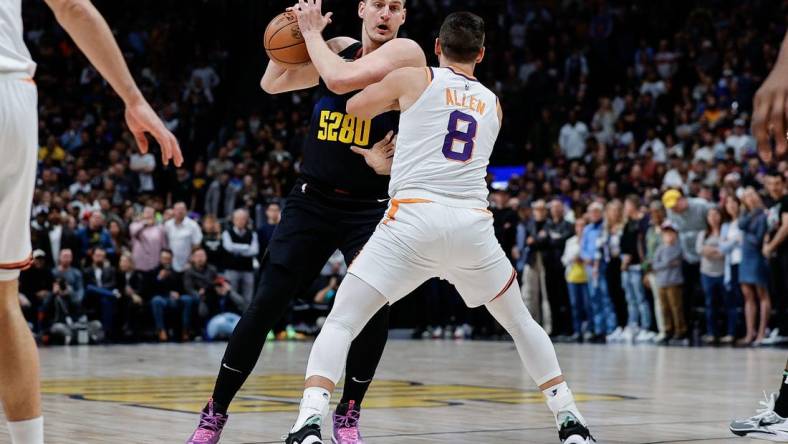 Mar 27, 2024; Denver, Colorado, USA; Denver Nuggets center Nikola Jokic (15) controls the ball as Denver Nuggets forward Peyton Watson (8) guards in the first quarter at Ball Arena. Mandatory Credit: Isaiah J. Downing-USA TODAY Sports