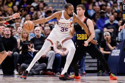 Mar 27, 2024; Denver, Colorado, USA; Phoenix Suns forward Kevin Durant (35) controls the ball as Denver Nuggets guard Collin Gillespie (21) guards in the second quarter at Ball Arena. Mandatory Credit: Isaiah J. Downing-USA TODAY Sports