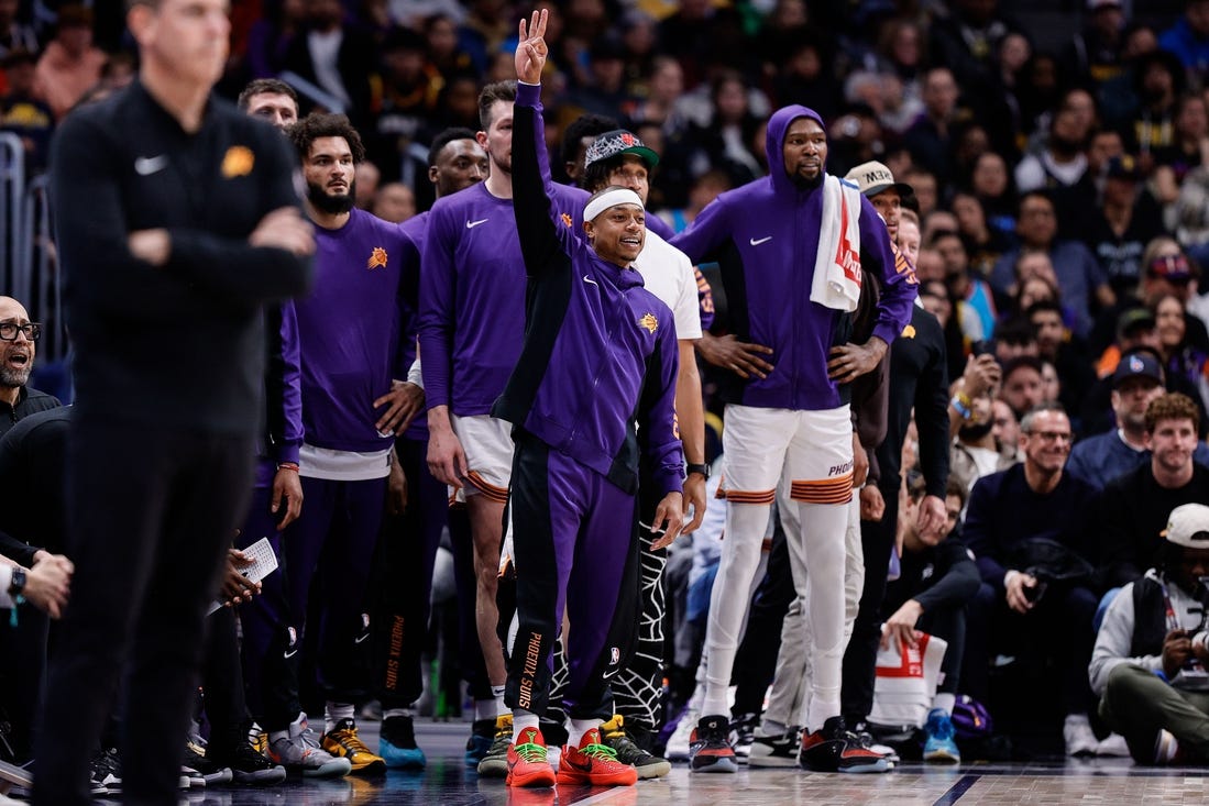 Mar 27, 2024; Denver, Colorado, USA; Phoenix Suns guard Isaiah Thomas (4) gestures from the bench in the fourth quarter against the Denver Nuggets at Ball Arena. Mandatory Credit: Isaiah J. Downing-USA TODAY Sports