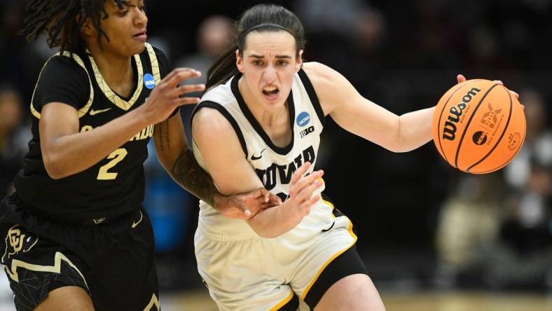 Iowa's Caitlin Clark (22) tries to get to the basket while guarded by Colorado's Tameiya Sadler (2) during the Sweet 16 of the NCAA college basketball tournament at Climate Pledge Arena in Seattle, WA on Friday, March 24, 2023.