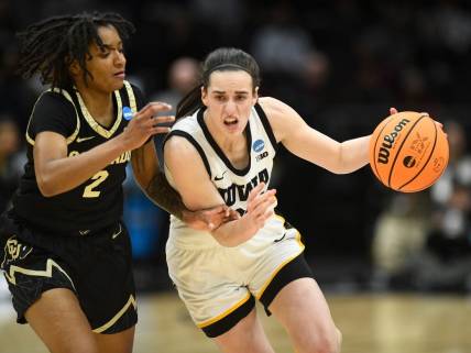 Iowa's Caitlin Clark (22) tries to get to the basket while guarded by Colorado's Tameiya Sadler (2) during the Sweet 16 of the NCAA college basketball tournament at Climate Pledge Arena in Seattle, WA on Friday, March 24, 2023.