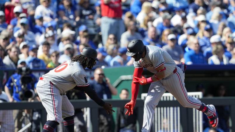 Mar 28, 2024; Kansas City, Missouri, USA; Minnesota Twins third baseman Royce Lewis (23) celebrates with third base coach Tommy Watkins after hitting a home run during the first inning against the Kansas City Royals at Kauffman Stadium. Mandatory Credit: Jay Biggerstaff-USA TODAY Sports