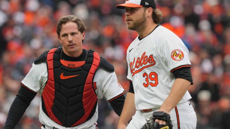 Mar 28, 2024; Baltimore, Maryland, USA; Baltimore Orioles pitcher Corbin Burnes (39) is greeted by catcher Adley Rutschman (35) after the second inning against the Los Angeles Angels at Oriole Park at Camden Yards. Mandatory Credit: Mitch Stringer-USA TODAY Sports