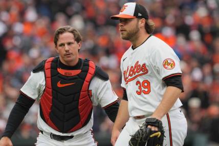 Mar 28, 2024; Baltimore, Maryland, USA; Baltimore Orioles pitcher Corbin Burnes (39) is greeted by catcher Adley Rutschman (35) after the second inning against the Los Angeles Angels at Oriole Park at Camden Yards. Mandatory Credit: Mitch Stringer-USA TODAY Sports