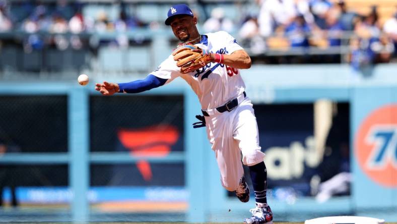 Mar 28, 2024; Los Angeles, California, USA; Los Angeles Dodgers outfielder Mookie Betts (50) throws to first for an out during the third inning of an opening day game against the St. Louis Cardinals at Dodger Stadium. Mandatory Credit: Jason Parkhurst-USA TODAY Sports