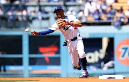Mar 28, 2024; Los Angeles, California, USA; Los Angeles Dodgers outfielder Mookie Betts (50) throws to first for an out during the third inning of an opening day game against the St. Louis Cardinals at Dodger Stadium. Mandatory Credit: Jason Parkhurst-USA TODAY Sports