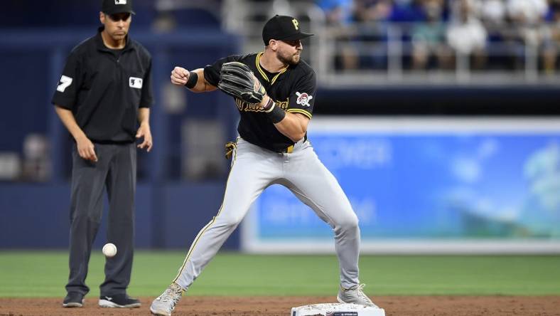 Mar 28, 2024; Miami, Florida, USA;  Pittsburgh Pirates second baseman Jared Triolo drops the ball while trying to turn a double play during the second inning against the Miami Marlins, at loanDepot Park. Mandatory Credit: Michael Laughlin-USA TODAY Sports