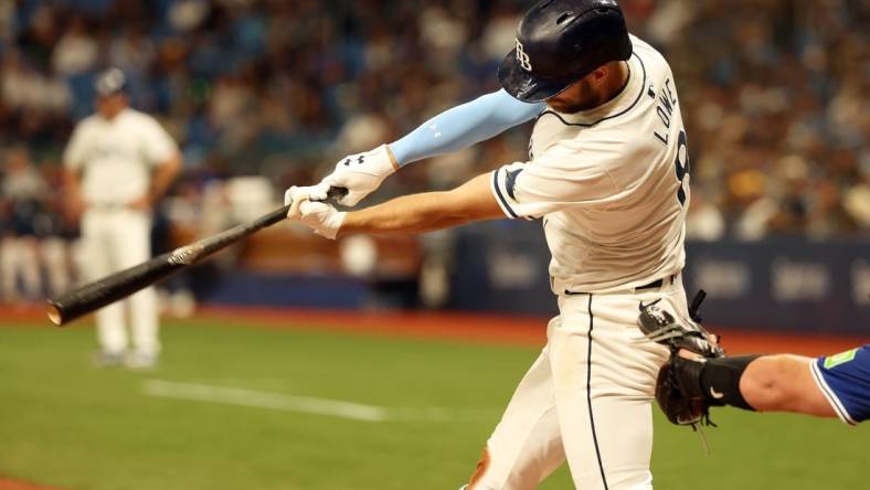 Mar 28, 2024; St. Petersburg, Florida, USA; Tampa Bay Rays first baseman Yandy Diaz (2) singles during the eighth inning against the Toronto Blue Jays at Tropicana Field. Mandatory Credit: Kim Klement Neitzel-USA TODAY Sports