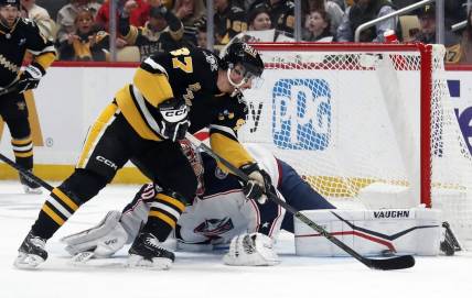 Mar 28, 2024; Pittsburgh, Pennsylvania, USA; Columbus Blue Jackets goaltender Daniil Tarasov (40) makes a pad save against Pittsburgh Penguins center Sidney Crosby (87) during the first period at PPG Paints Arena. Mandatory Credit: Charles LeClaire-USA TODAY Sports
