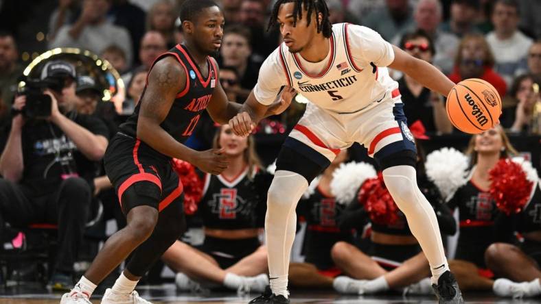 Mar 28, 2024; Boston, MA, USA; Connecticut Huskies guard Stephon Castle (5) dribbles the ball against San Diego State Aztecs guard Darrion Trammell (12) in the semifinals of the East Regional of the 2024 NCAA Tournament at TD Garden. Mandatory Credit: Brian Fluharty-USA TODAY Sports