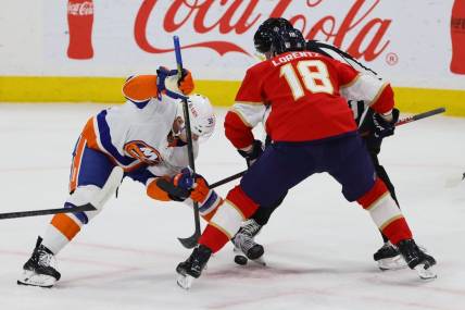 Mar 28, 2024; Sunrise, Florida, USA; New York Islanders center Kyle MacLean (32) and Florida Panthers center Steven Lorentz (18) face-off during the first period at Amerant Bank Arena. Mandatory Credit: Sam Navarro-USA TODAY Sports